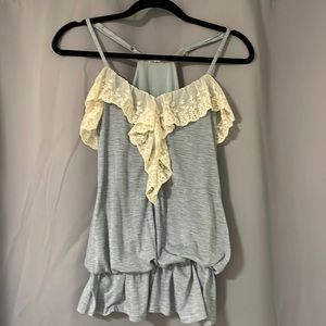 Beautiful razor back dressy tank with lace ruffle front. Bubble cinched waist.